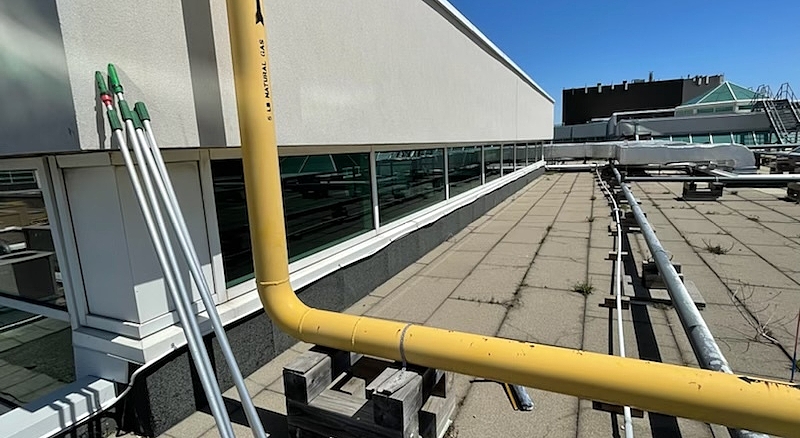 Industrial rooftop with Tucker poles laid out, ready for use in cleaning high windows and glass panels