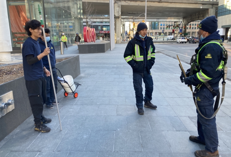 Safety talk being delivered by a supervisor to window cleaning staff, ensuring proper precautions are taken before starting work